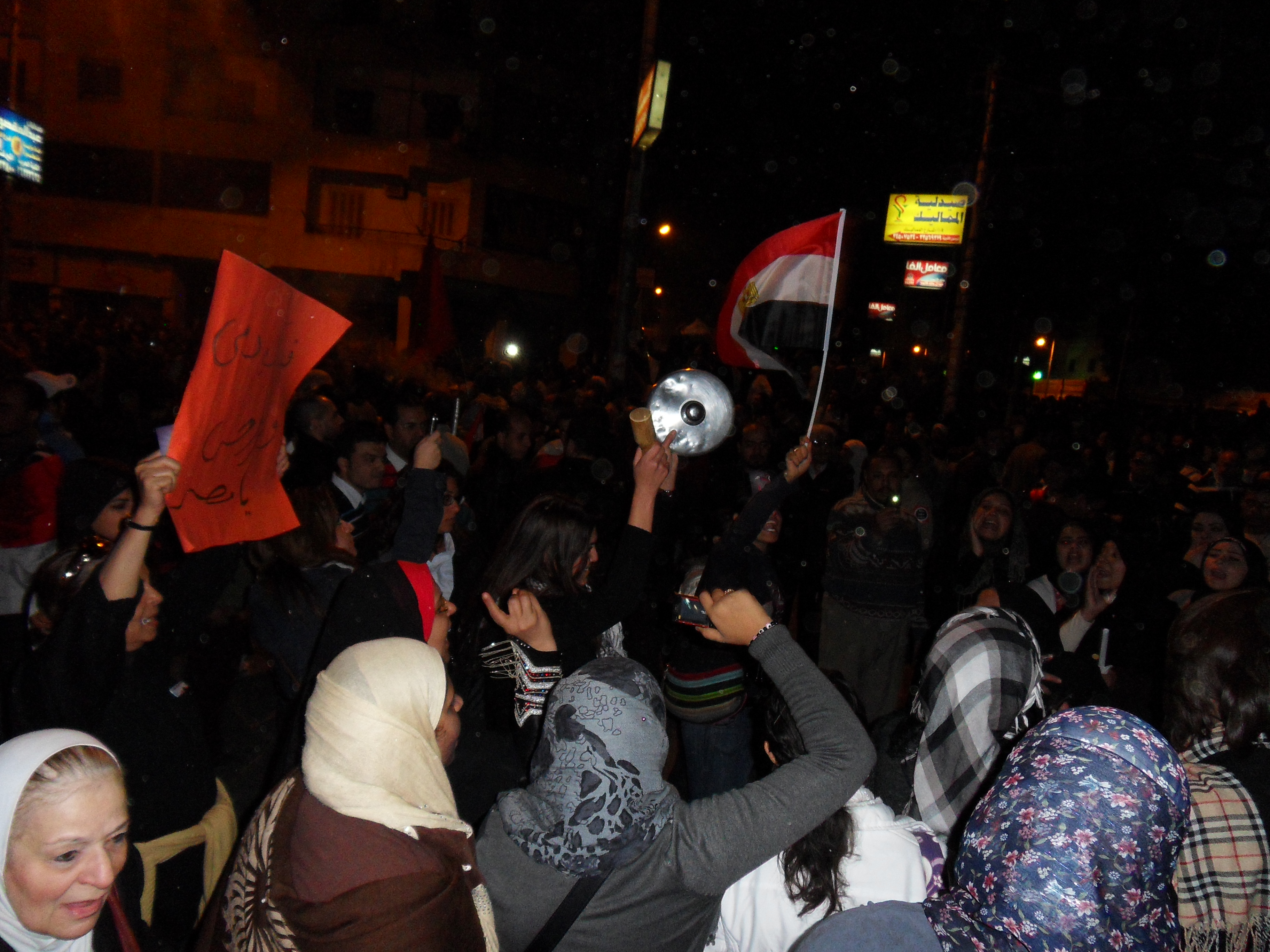Women singing songs and chanting against Morsi.