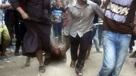 One of the victims being dragged in the streets