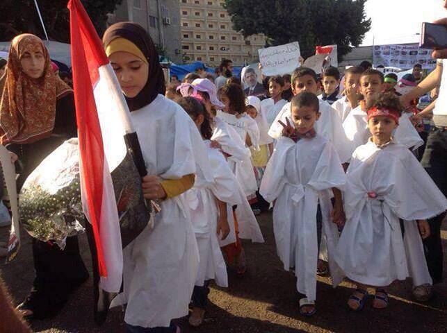 Egyptian Children dressed in 'white death shrouds' at a pro-Morsi demonstration