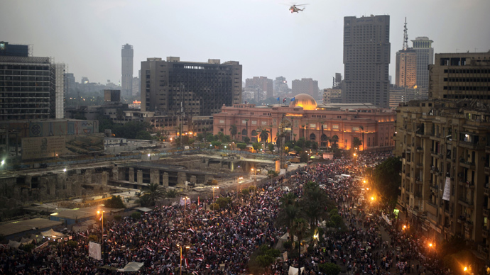 An Egyptian Military helicopter flies over protesters in Tahrir Square earlier today. 