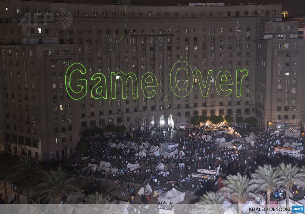 Protesters in Tahrir Square use lasers to demanding President Morsi's resignation