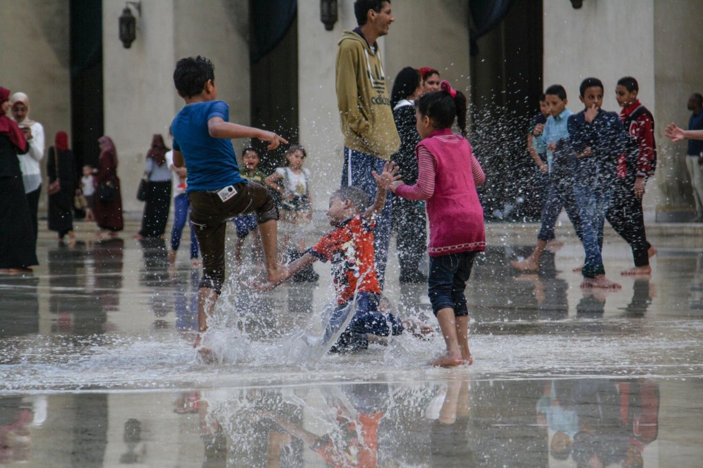 Kids playing with rainwater inside a mosque in Cairo. Credit: Enas El Masry