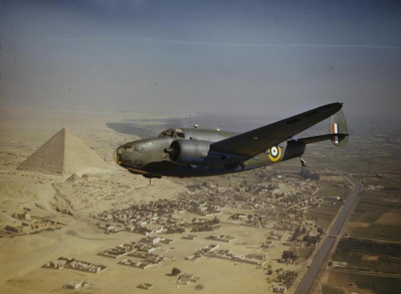 A military plane flies over the Pyramids in 1942