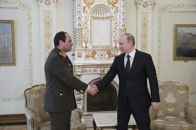 Military Chief Al-Sisi shakes hands with Russia's Putin in a visit to Moscow to discuss a historic arms deal.