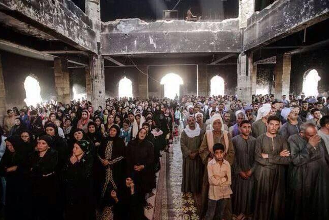 Coptic Christians pray in a church which was torched shortly after the ouster of Islamist President Mohammed Morsi