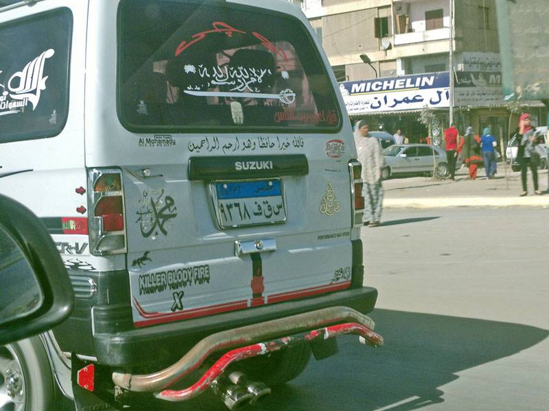 Micro-bus vehicle with religious stickers.