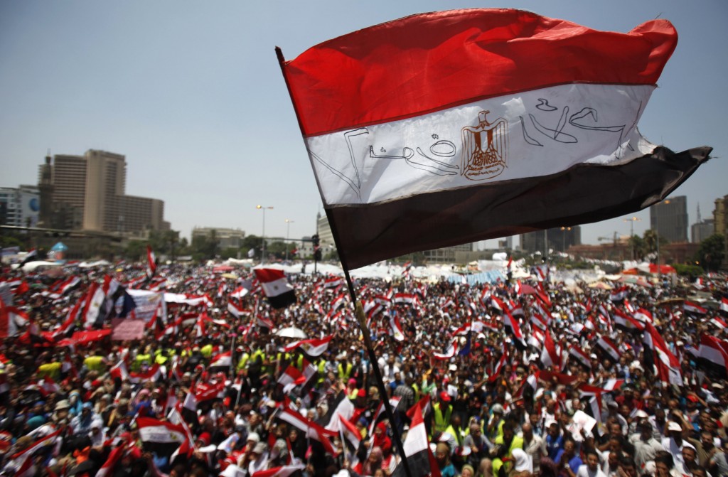 Protesters opposing Egyptian President Mohamed Mursi wave Egyptian flags and shout slogans against him and members of the Muslim Brotherhood at Tahrir square in Cairo