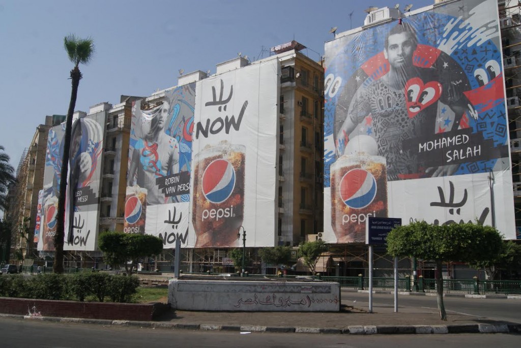 Giant pepsi ads featuring soccer starts cover an entire side of Tahrir square, the heart of the city. 