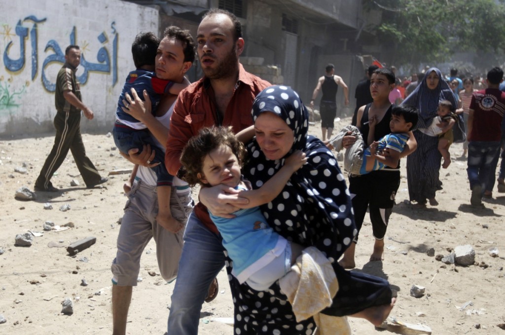 A Palestinian family flees after an air-strike in Gaza. Credit: Reuters