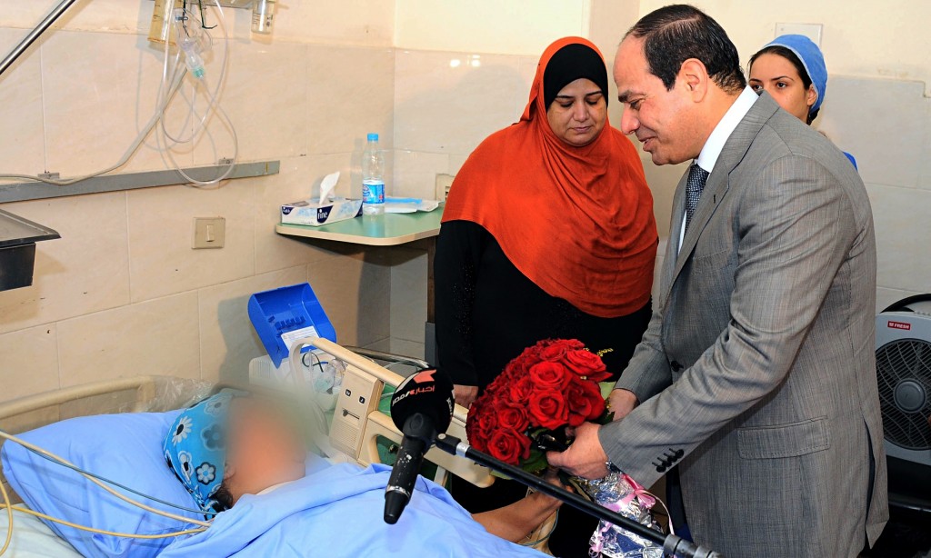 Egypt's President Sisi visits a sexual assault victim in hospital in June 2014.