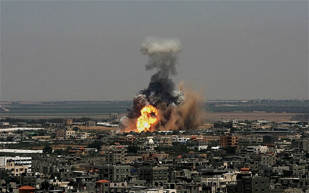 Smoke and flames are seen following an alleged air strike which bombarded dozens of targets in the Gaza Strip, Israel on Tuesday Photo: Corbis