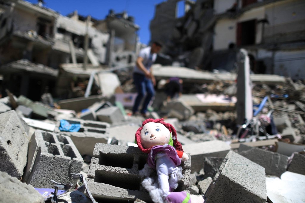 A Palestinian doll lies on the rubble of a destroyed building Abu Lealla family following an Israeli air strike in Gaza City on July 11, 2014. (Wissam Nassar/The New York Times)