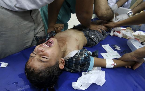 Medics tend to a boy injured in the shelling of a Gaza hospital. Photo: Reuters