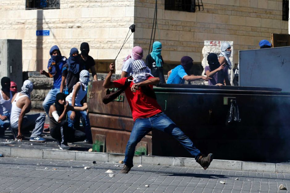 Masked Palestinian residents clash with Israeli police in Shuafat, a suburb of Jerusalem. Reuters: Baz Ratner