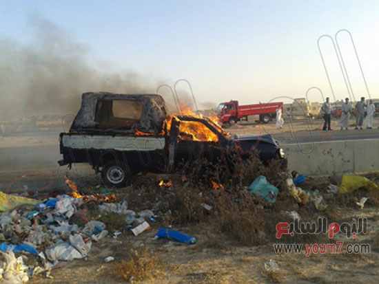 Police car catches fire after militant attack. Photo: Al-Youm7