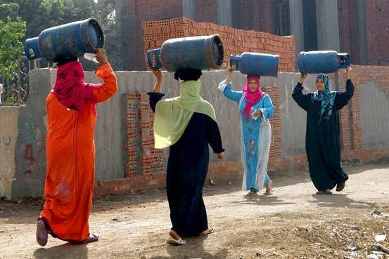 Women carrying empty gas cylinders, as Egypt's government said it lifted a subsidy on butane cooking gas. Photo: Reuters.