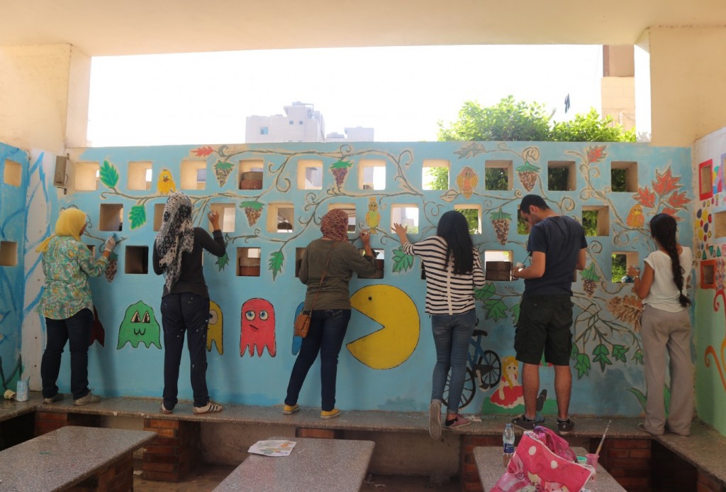 Volunteers add colours and drawings to the walls that the children see during their stay at the hospital (Credit: Leena ElDeeb)