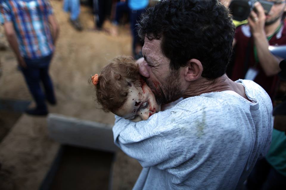 A father says his last good bye to his daughter that was killed in an Israeli air-strike in Gaza.