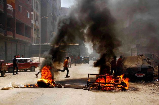 Pro-Morsi demonstrators blocked roads on Thursday, 14 August, by setting fire to waste in Matariya Square, Cairo, Egypt. Photo: AP.