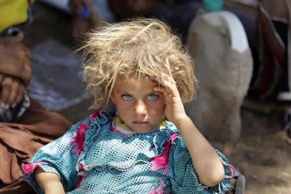 One Yazidi girl among thousands who were able to escape life-threatening conditions on Mount Sinjar to a makeshift refugee camp in Dohuk province in this Reuters image.