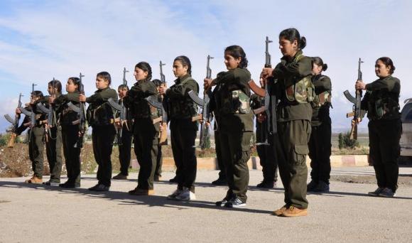 Kurdish female fighters of the Kurdish People's Protection Units (YPJ) hold their weapons at a military training camp in Malikiya, Hassaka province December 9, 2013. Credit: Reuters/Rodi Said