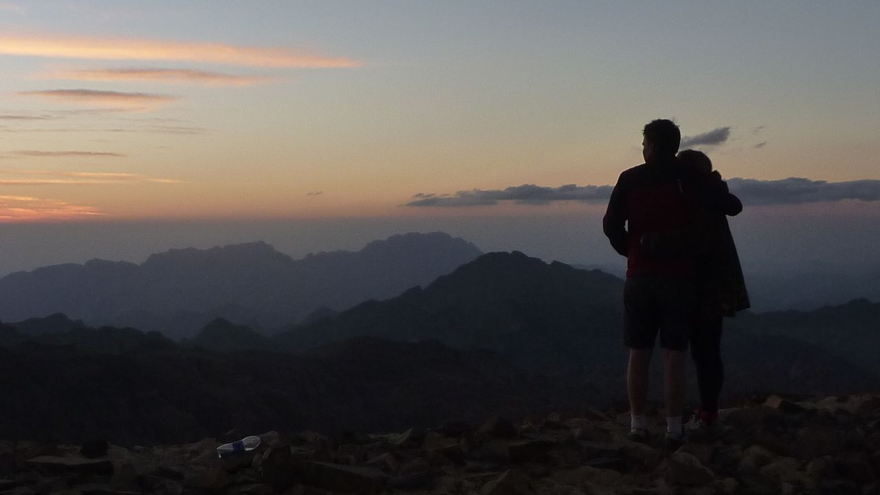 Two hikers, watching the sun go down from Jebel Abbas Basha