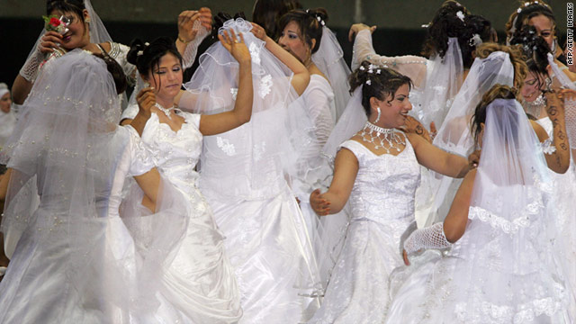 Newly wed brides dance at a mass wedding ceremony in Cairo, Egypt (2010).