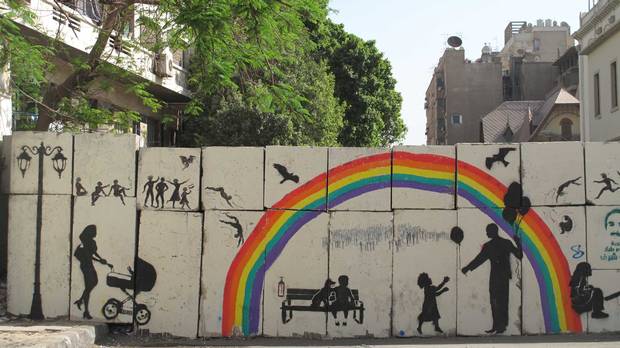 Artwork titled, Tomorrow, painted by El-Zeft on the walls of Mansour street in Cairo, Egypt. The painting shows an image that contrasts with the current reality; the rainbow and playfulness display an idealistic future that contrasts with the massacres that are taking place. (Photo credit: Mia Grondahl)