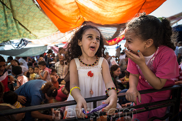 Two Egyptian girls play during a gathering at a church as they celebrate the traditional festival “Sham el-Nessim” in 2014. Credit: Pan Chaoyue