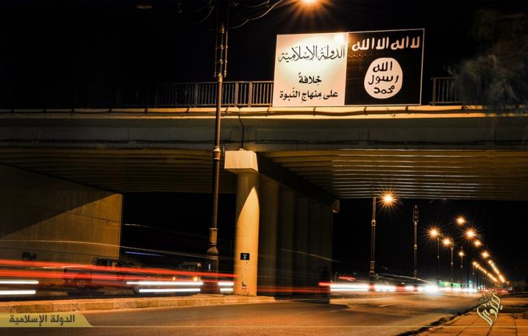The Islamic State group's flag over a bridge in Mosul