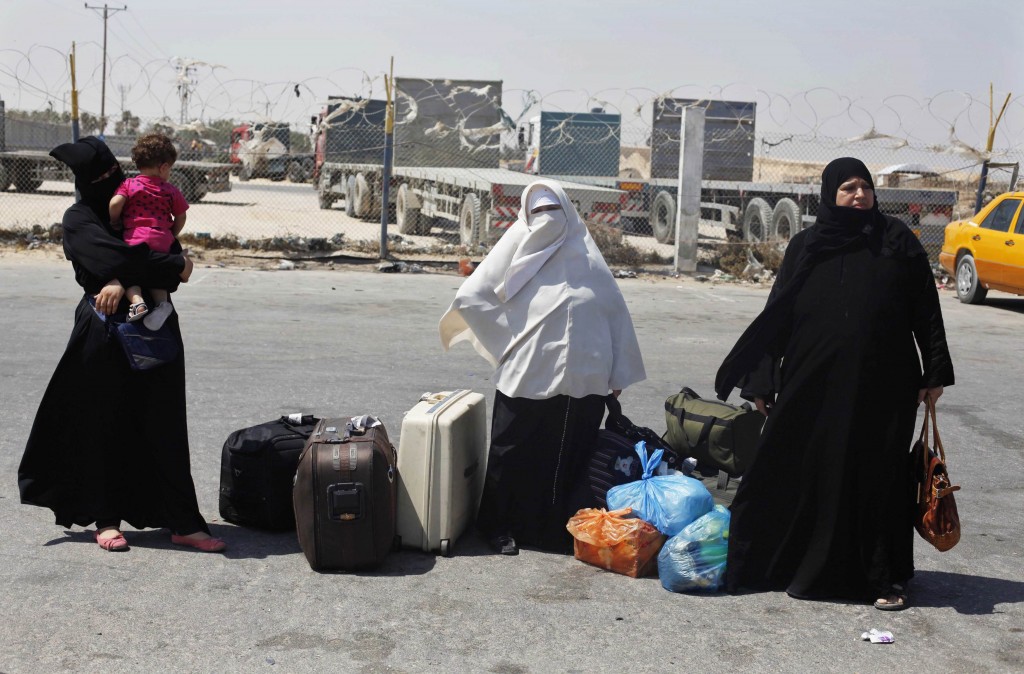 Palestinian passengers wait to leave Rafah crossing between Egypt and southern Gaza Strip after the crossing's closure