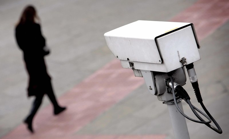 A police CCTV camera observes a bypassing woman. Credit: Leon Neal/AFP 
