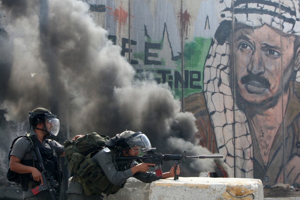 Israeli soldiers clash with Palestinian stone throwers at a checkpoint outside Jerusalem. Credit: Ahmad Gharabli/ AFP