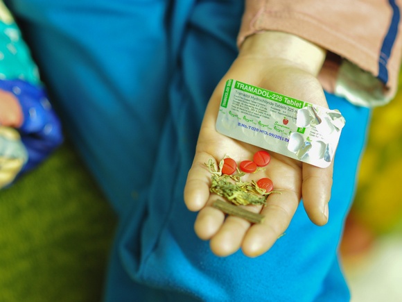 A drug user presenting Tramadol pills and hashish in his palm. Credit: Gaël Favari/The Global Journal