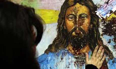 A blood-spattered image of Jesus Christ inside the the Coptic Christian Saints Church in Alexandria. Credit: Reuters