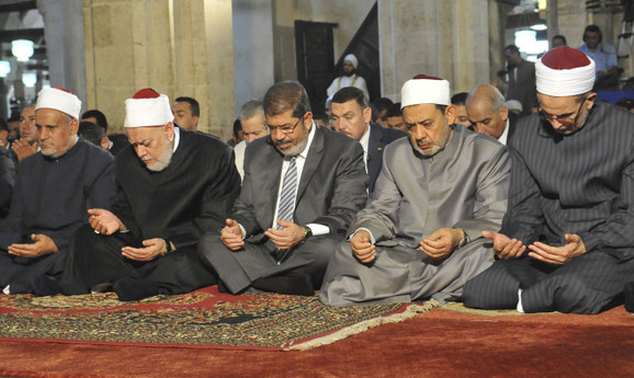 Egypt’s Mohamed Morsi (C), the Grand Sheikh of Al-Azhar Ahmed El-Tayeb (R), and Egypt’s Mufti Ali Gomaa (2nd L) during the Al-Gomaa prayer at Al-Azhar mosque in Cairo August 17, 2012. (Photo credit: Egyptian Presidency/Handout)