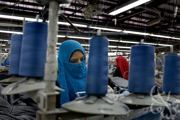 Egyptian workers operate a production line for blue jeans at the Velocity Apparelz CO factory October 27, 2008. Credit: Scott Nelson