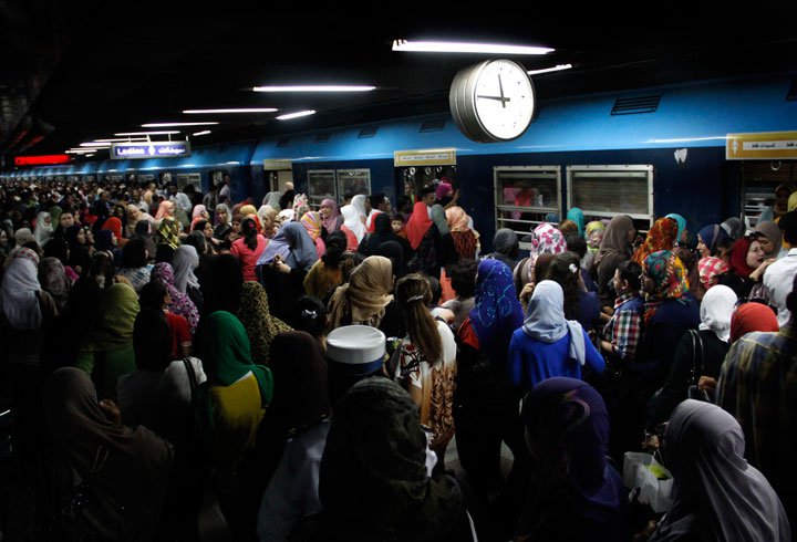 Crowds push their way through al-Sayeda Zeinab metro station in Cairo. Credit: Heba Elkholy/ AP