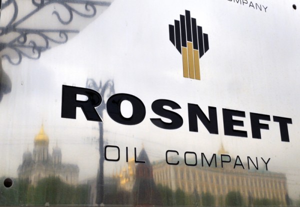 The Kremlin is reflected in the polished company plate of the state-controlled Russian oil giant Rosneft at the entrance of the headquarters in Moscow. Credit: Dmitry Kostyukov/AFP