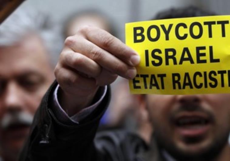 Man holds boycott Israel sign. Credit: Francois Lenoir/ Reurters