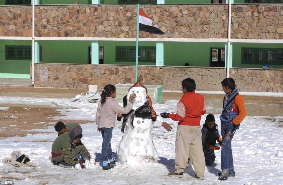 Children in Saint Catherine building a snowman at the school yard during a rare snowstorm that blanketed most of the Middle East in December 2014. Source: EPA