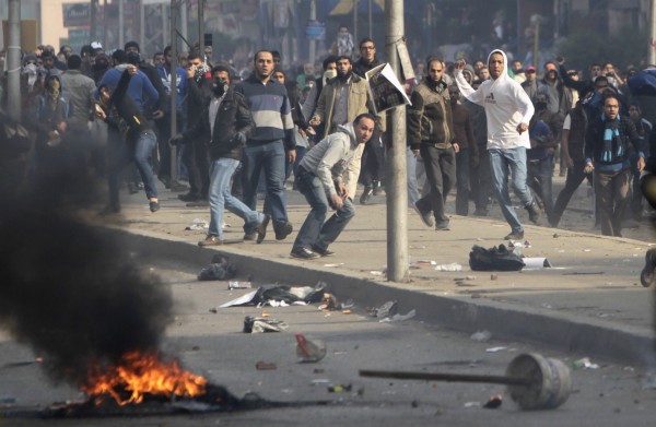 Supporters of Muslim Brotherhood and ousted President Mursi clash with riot police during clashes at Nasr City district in Cairo