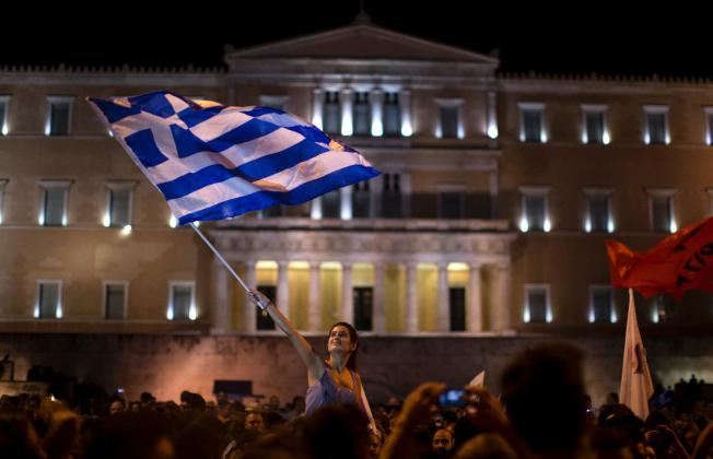 A 'No' supporter celebrates after the outcome of the referendum came out.  AP Photo/Emilio Morenatti)