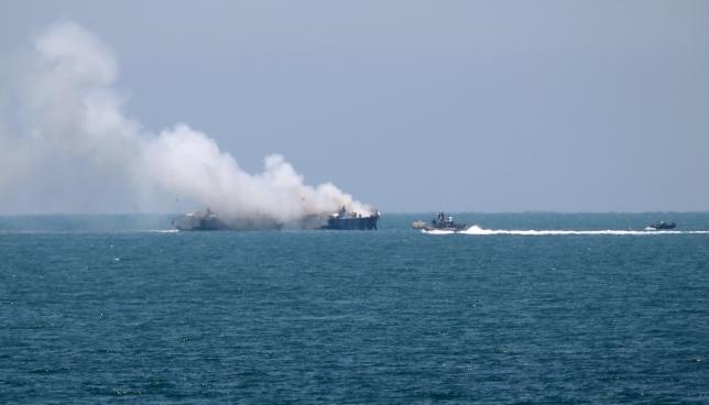 Smokes rises from an Egyptian coastguard vessel on the coast of northern Sinai, after apparently being hit by an ISIS rocket. The scene was photographed from the border of southern Gaza Strip with Egypt, on July 16, 2015. Credit: Reuters