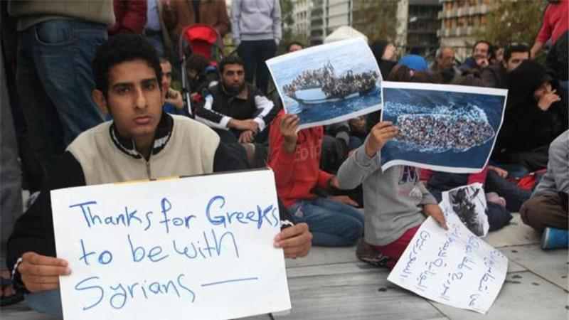 Syrian refugees gather at Syntagma Square calling for Greek government assistance. Source: Getty