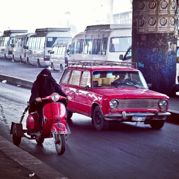 A veiled woman driving a motorbike in Cairo. Photo by Roger Anis
