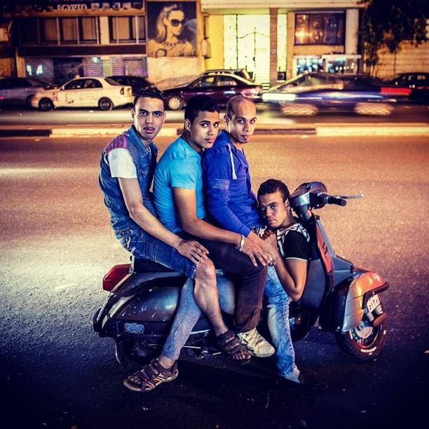 Egyptian youth riding a 'vesba' in Cairo. Photo by Roger Anis