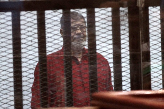 Former President Mohamed Mursi in his first appearance in a red prison uniform during a court hearing, on June 21, 2015/ASWAT MASRIYA
