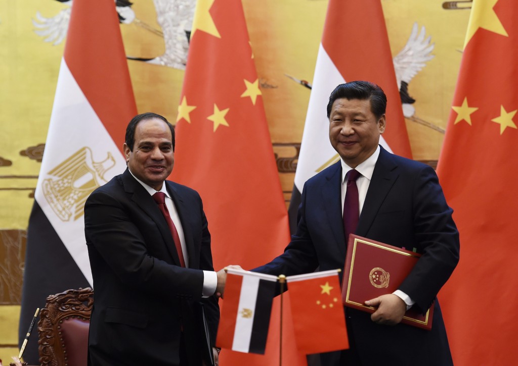 Egypt's President Sisi shakes hands with Chinese President Xi during a signing ceremony in the Great Hall of the People in Beijing
