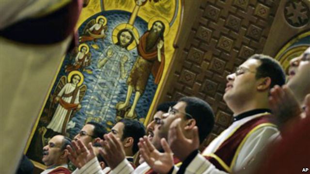 Egyptian Coptic deacons pray during Christmas mass at Saint Mark Coptic Orthodox Cathedral in Cairo. Credit: AP